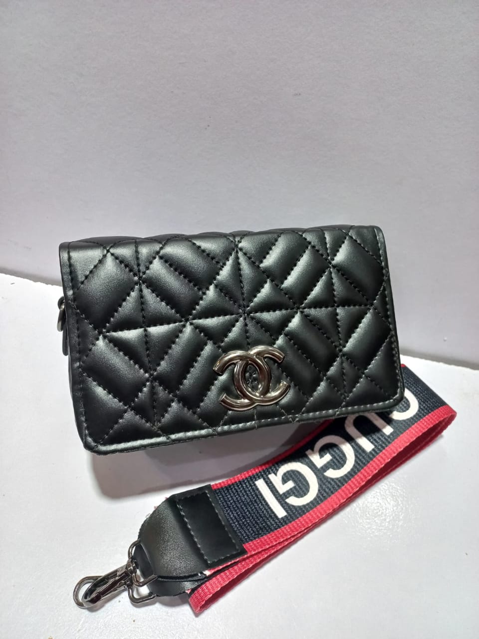 Elegant Quilted Black Handbag with Branded Strap with Guchi brand logo